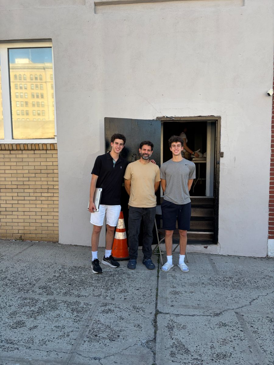 Daniel and Liam Wellisch with a partner outside the CSA Kitchen building in Mount Vernon