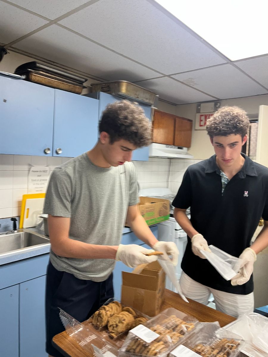 Daniel and Liam bagging baked goods at the soup kitchen